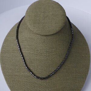 Women`s silver tone hematite look bead necklace.